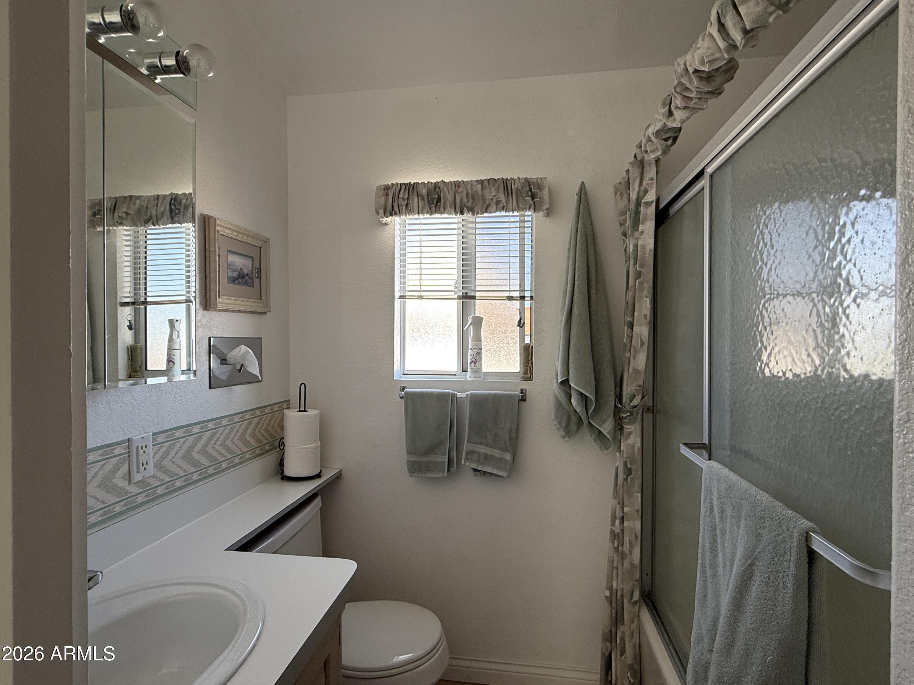 21340 Trading Post Trail Congress, AZ 85332 - Photo 20 of 31 a bathroom with a toilet sink and mirror