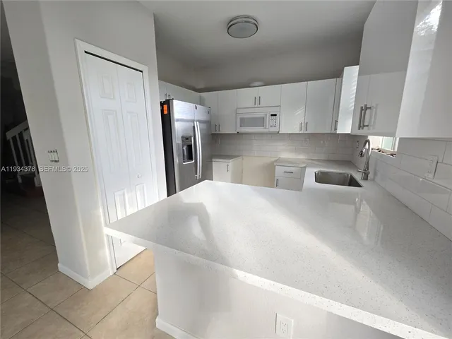 a kitchen with stainless steel appliances a refrigerator and a sink
