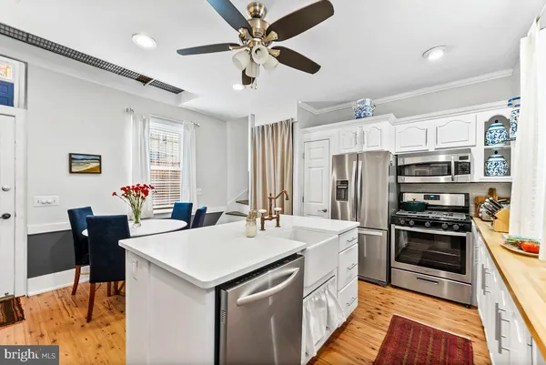 a kitchen with refrigerator cabinets and furniture