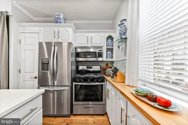 a kitchen with stainless steel appliances granite countertop a refrigerator and a stove