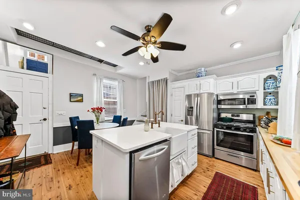a kitchen with a sink stainless steel appliances and furniture