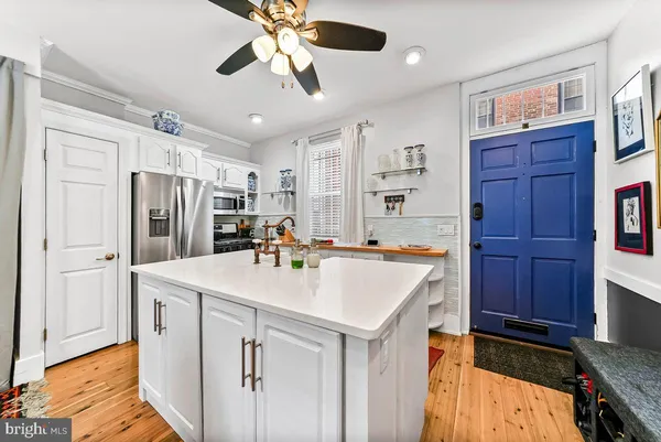 a kitchen with stainless steel appliances granite countertop a sink and cabinets
