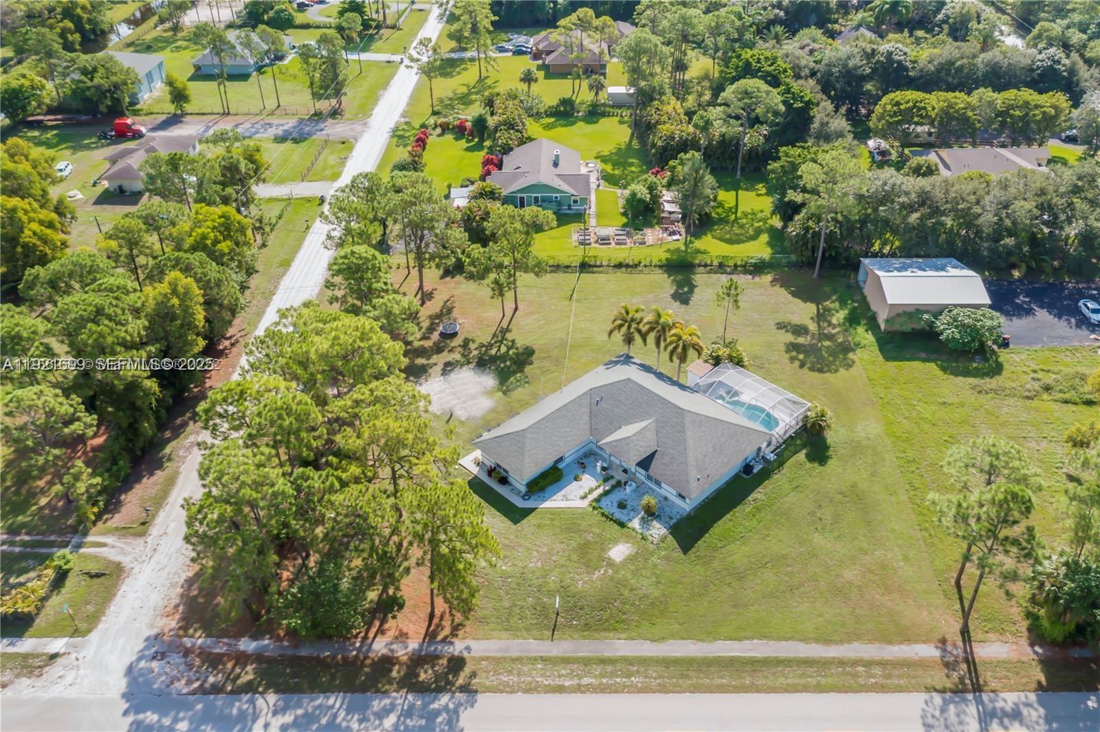 an aerial view of a house with yard swimming pool and outdoor seating