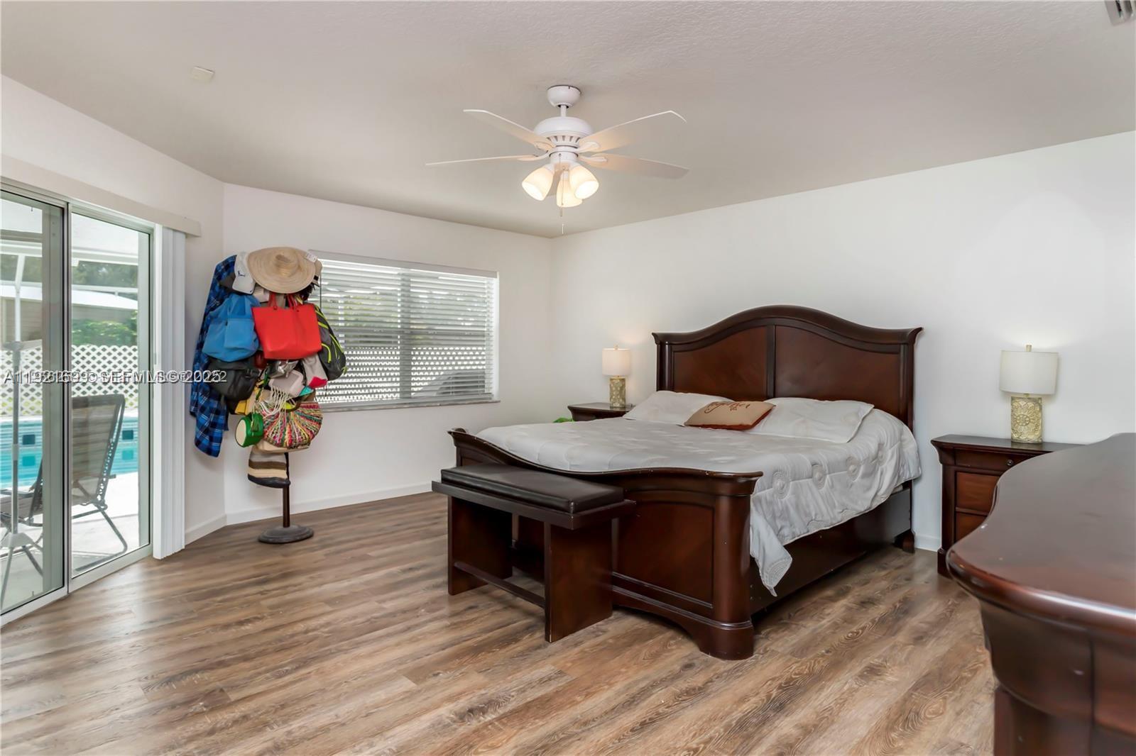 17996 North 42nd Road North Loxahatchee, FL 33470 - Photo 11 of 34 a bedroom with a bed and wooden floor