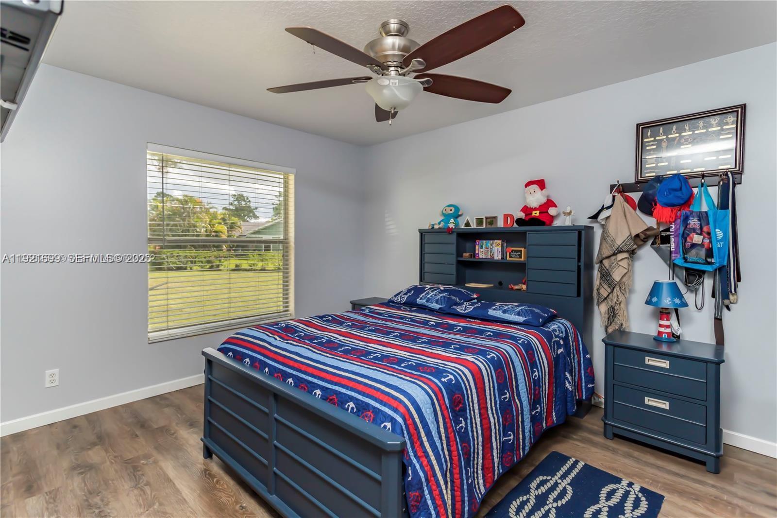 17996 North 42nd Road North Loxahatchee, FL 33470 - Photo 14 of 34 a bedroom with a bed and a window