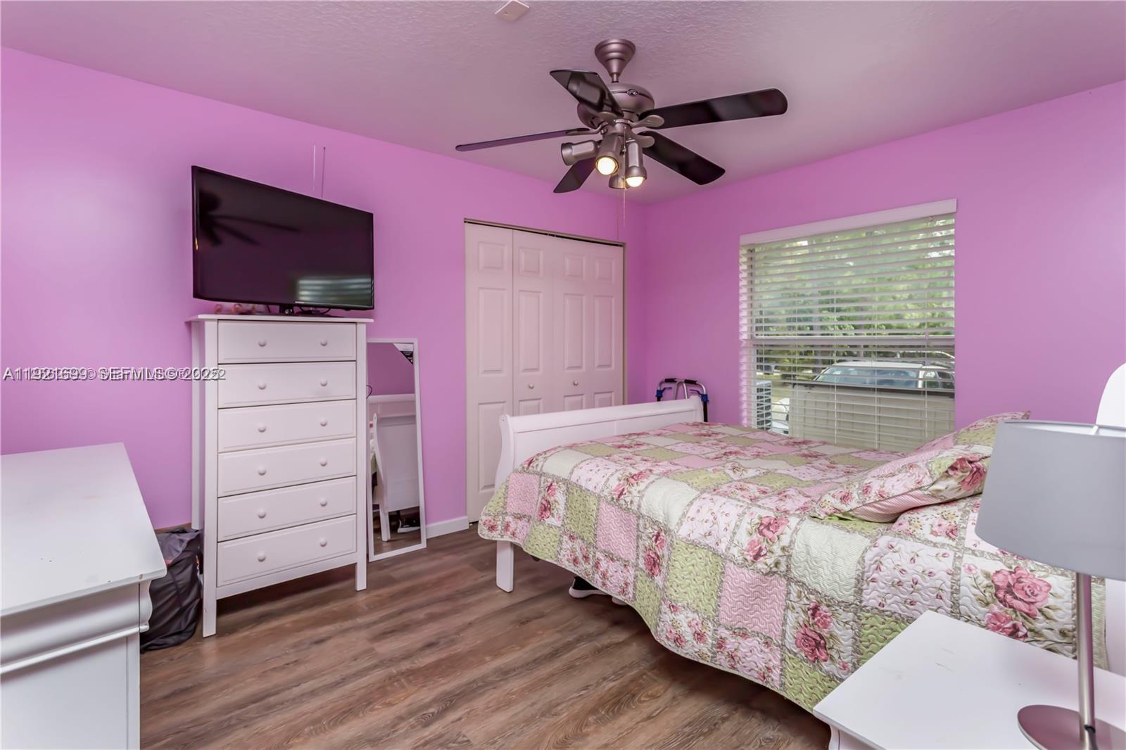 17996 North 42nd Road North Loxahatchee, FL 33470 - Photo 15 of 34 a bedroom with a bed a flat screen tv and a dresser