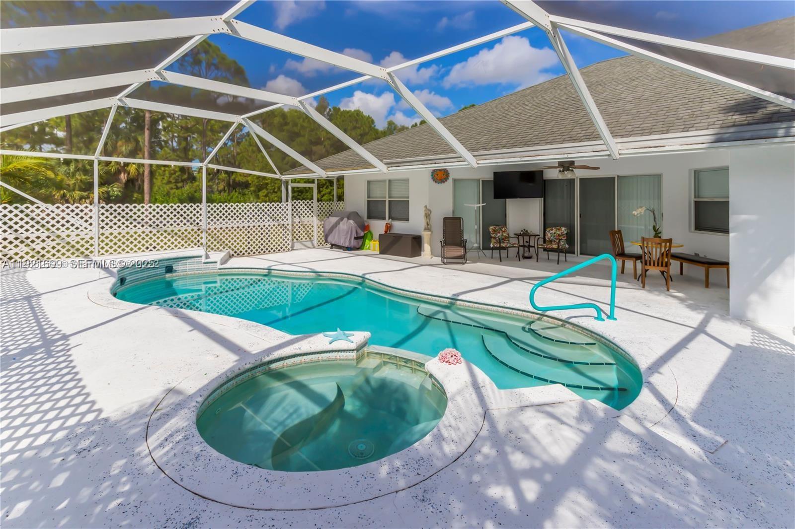 17996 North 42nd Road North Loxahatchee, FL 33470 - Photo 21 of 34 a view of a swimming pool with outdoor seating