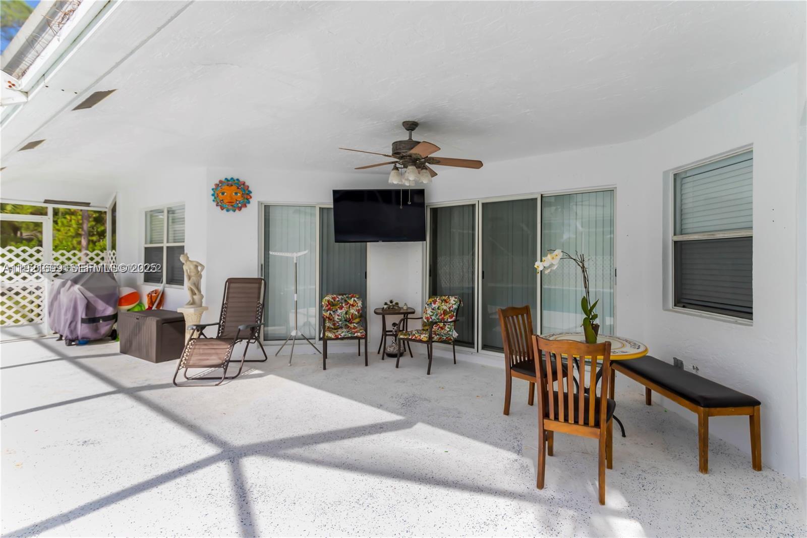 17996 North 42nd Road North Loxahatchee, FL 33470 - Photo 22 of 34 a living room with furniture a rug and a chandelier