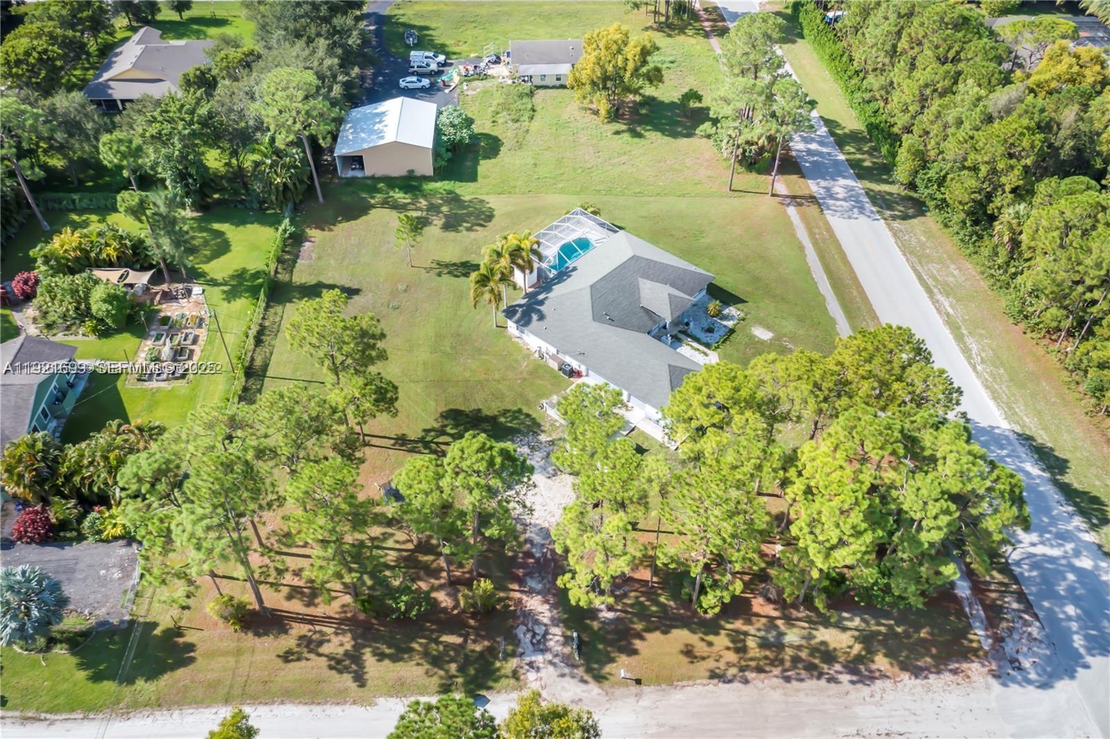 17996 North 42nd Road North Loxahatchee, FL 33470 - Photo 27 of 34 an aerial view of a house with a yard and lake view