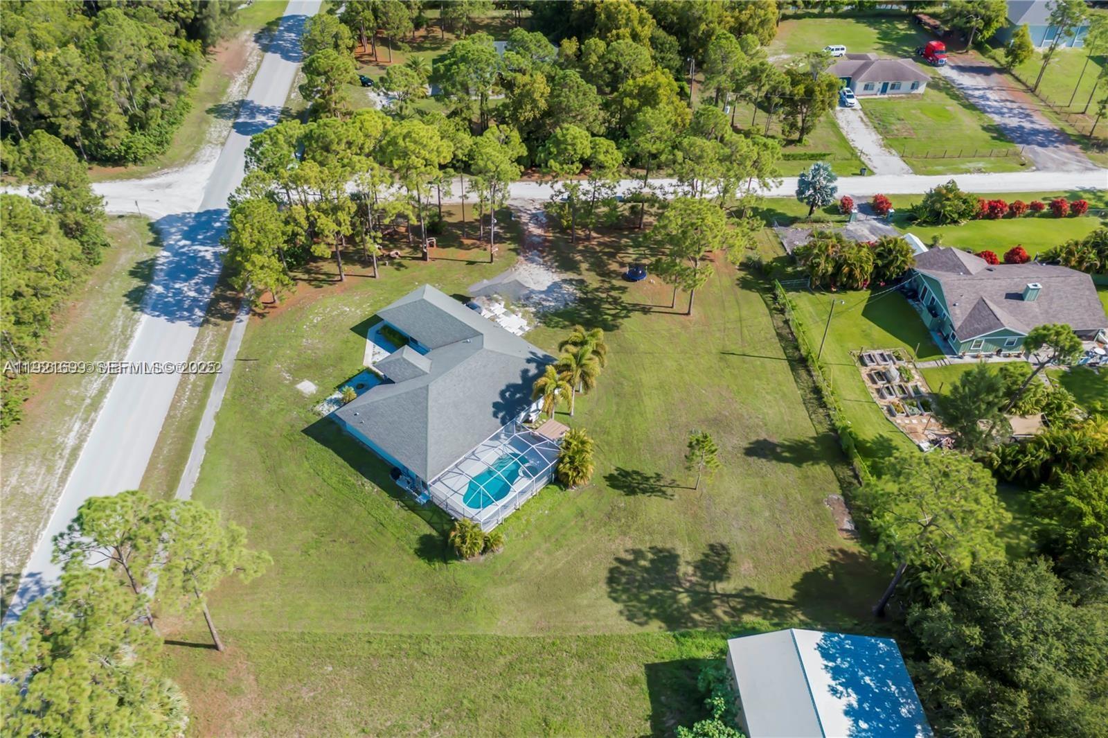 17996 North 42nd Road North Loxahatchee, FL 33470 - Photo 28 of 34 an aerial view of residential houses with outdoor space