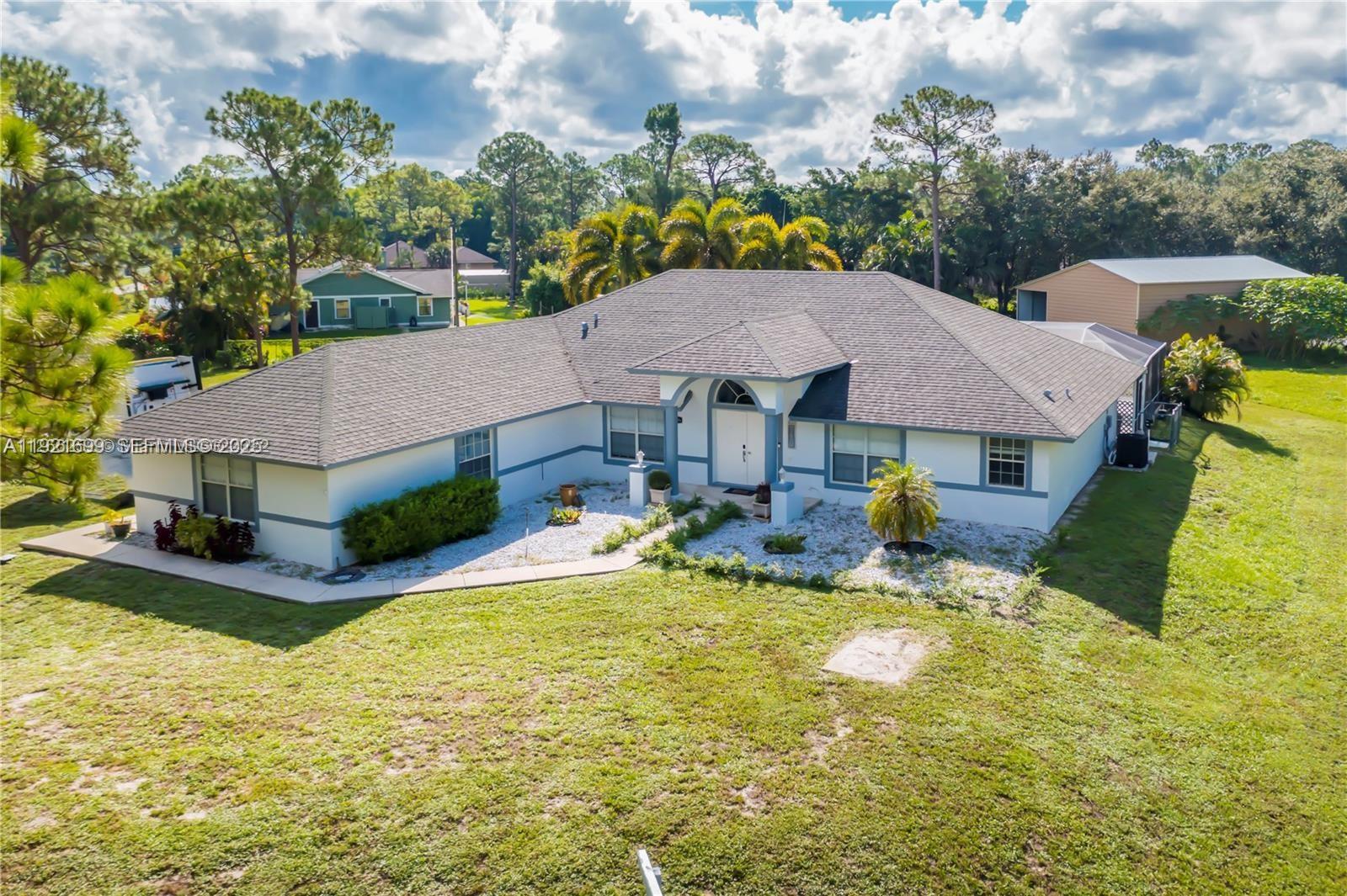 17996 North 42nd Road North Loxahatchee, FL 33470 - Photo 30 of 34 a view of a house with swimming pool and sitting area