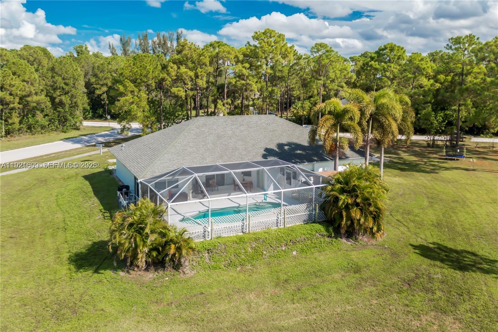 17996 North 42nd Road North Loxahatchee, FL 33470 - Photo 31 of 34 a view of a swimming pool with a yard