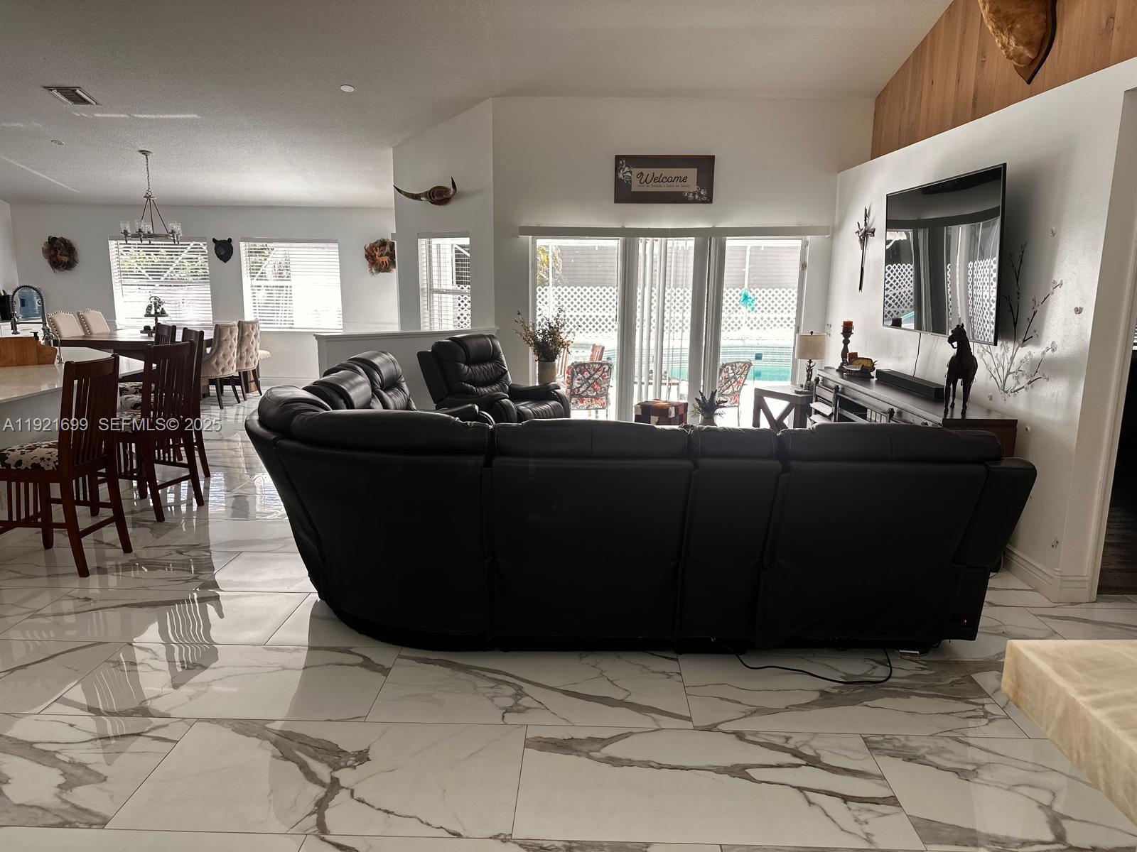 17996 North 42nd Road North Loxahatchee, FL 33470 - Photo 32 of 34 a living room with kitchen island furniture and a window
