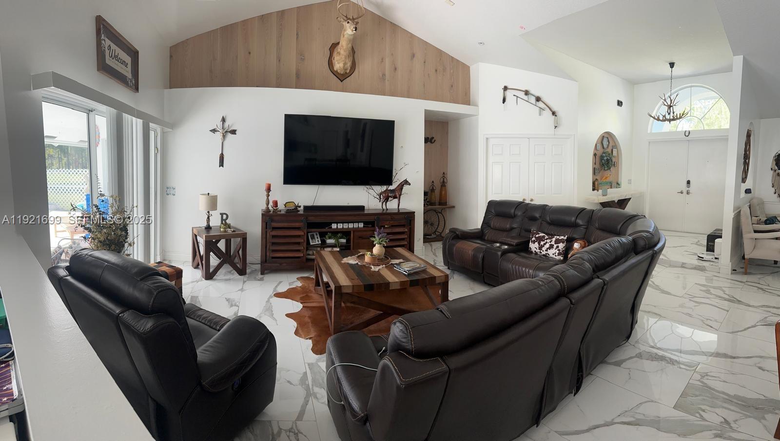 17996 North 42nd Road North Loxahatchee, FL 33470 - Photo 34 of 34 a living room with furniture and a flat screen tv