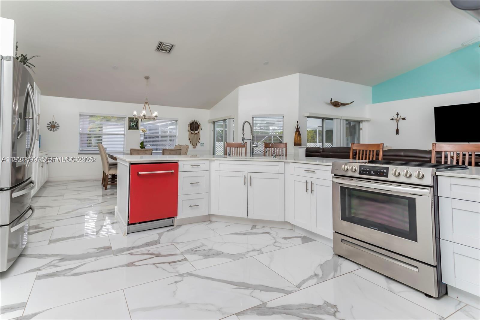 17996 North 42nd Road North Loxahatchee, FL 33470 - Photo 5 of 34 a kitchen with stainless steel appliances a stove top oven and cabinets