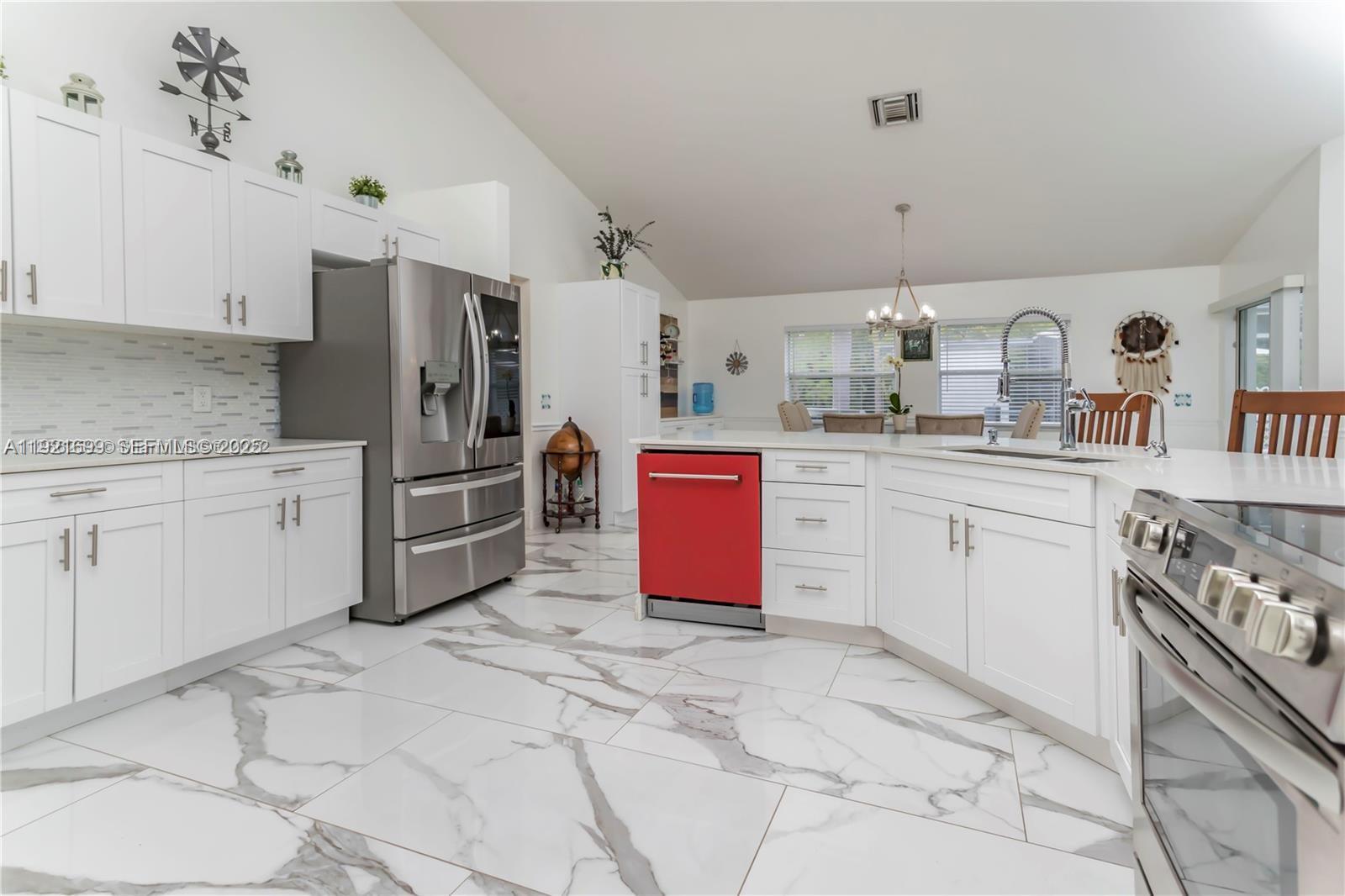 17996 North 42nd Road North Loxahatchee, FL 33470 - Photo 6 of 34 a kitchen with granite countertop a sink stove refrigerator and cabinets