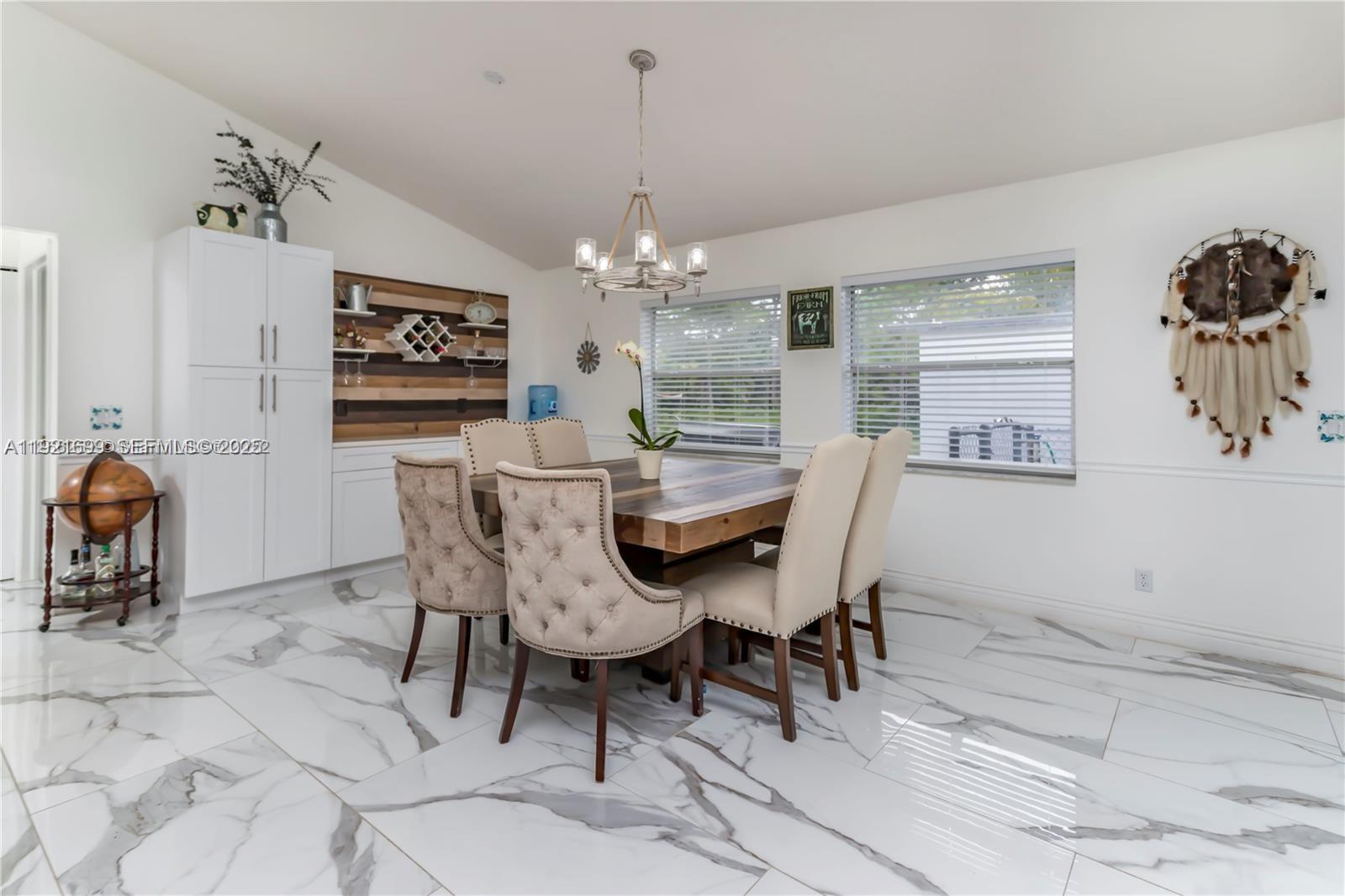 17996 North 42nd Road North Loxahatchee, FL 33470 - Photo 8 of 34 a dining room with furniture a chandelier and window