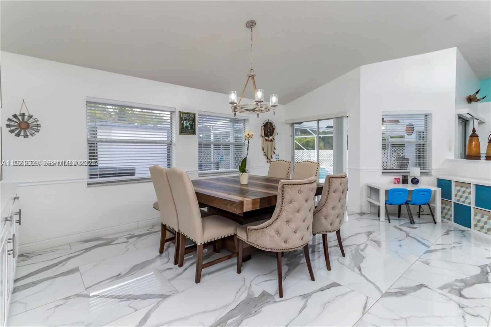 17996 North 42nd Road North Loxahatchee, FL 33470 - Photo 9 of 34 a dining room with furniture a chandelier and window