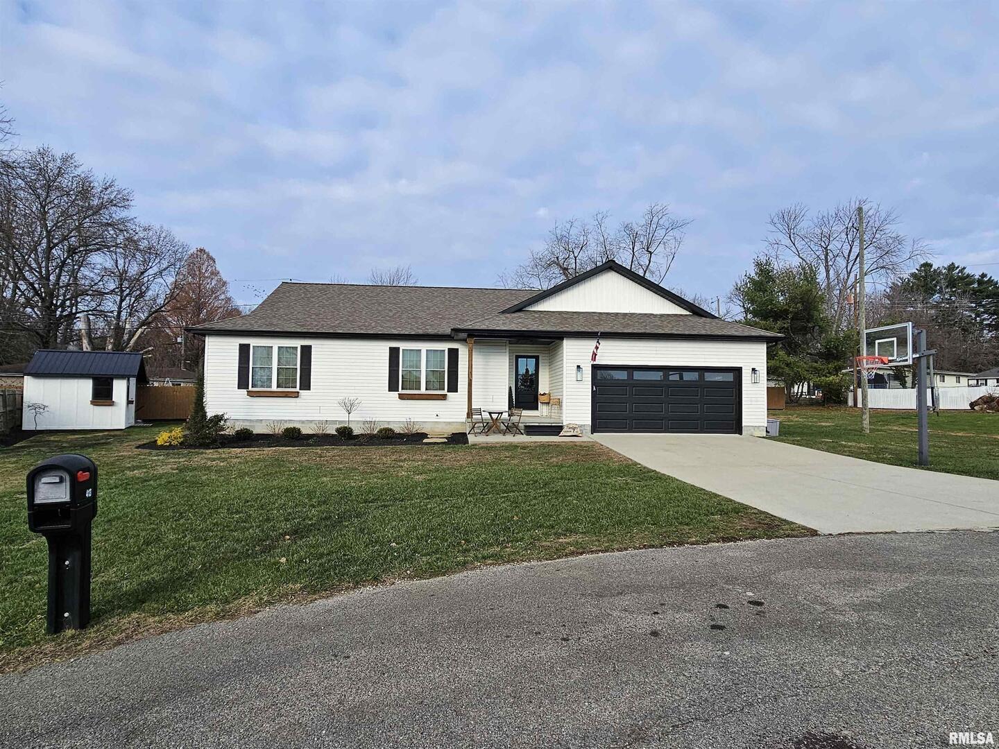 413 West Beacon Court Mount Vernon, IL 62864 - Photo 15 of 34 a front view of a house with a garden and yard