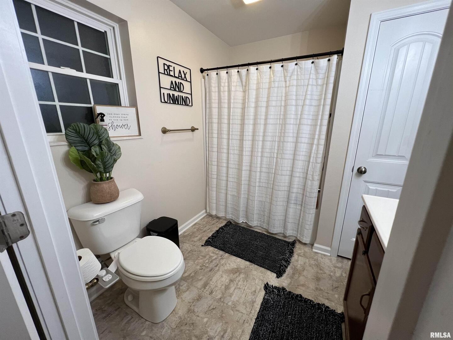 413 West Beacon Court Mount Vernon, IL 62864 - Photo 28 of 34 a white toilet sitting next to a shower curtain
