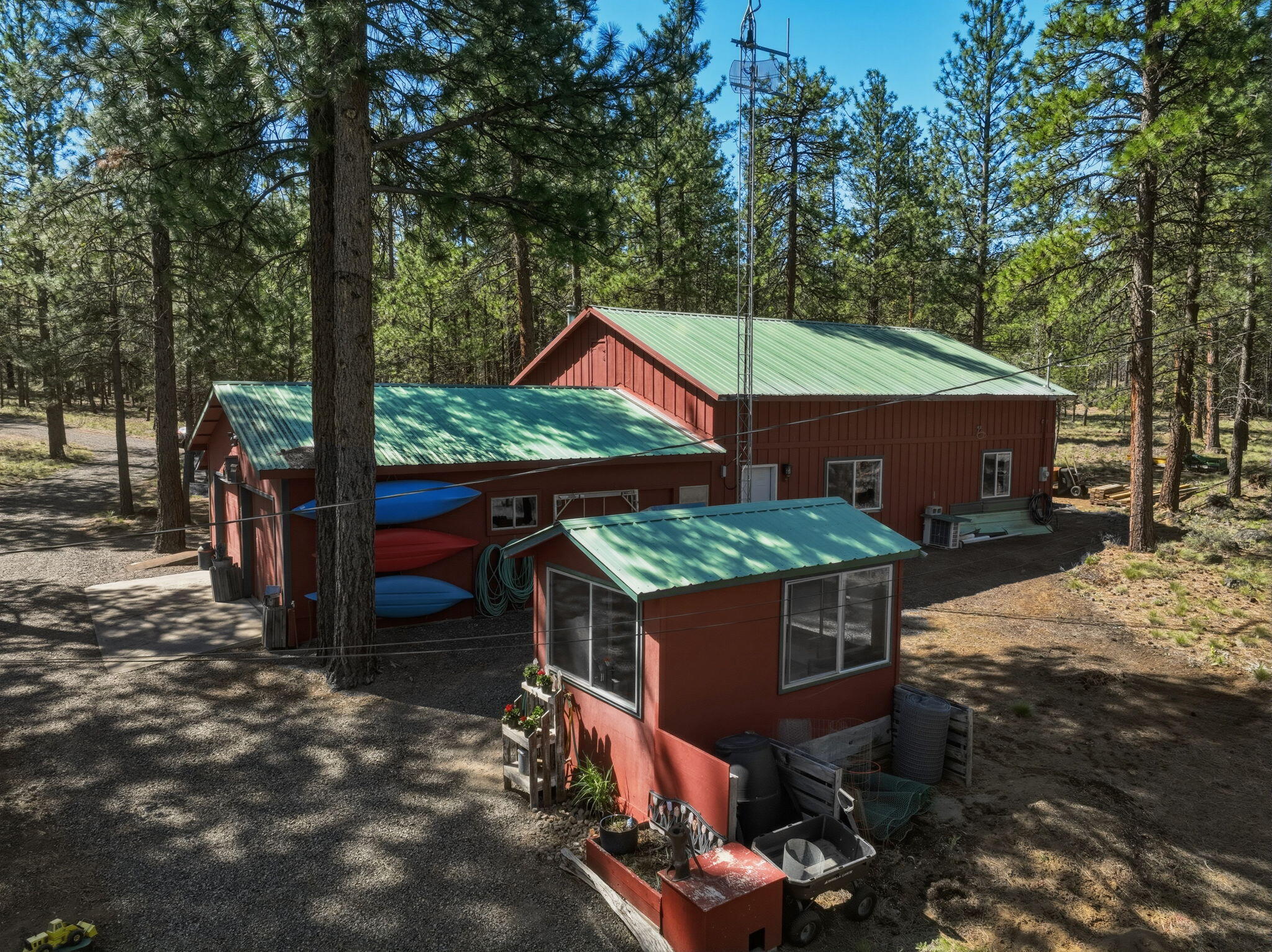 15020 Remuda Road Sisters, OR 97759 - Photo 39 of 61 Pump house in foreground. 28'x30' shop with 28'x16' RV bay and two additional 22'x14' rooms