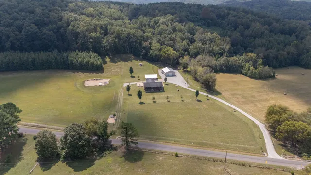 an aerial view of a house with a yard