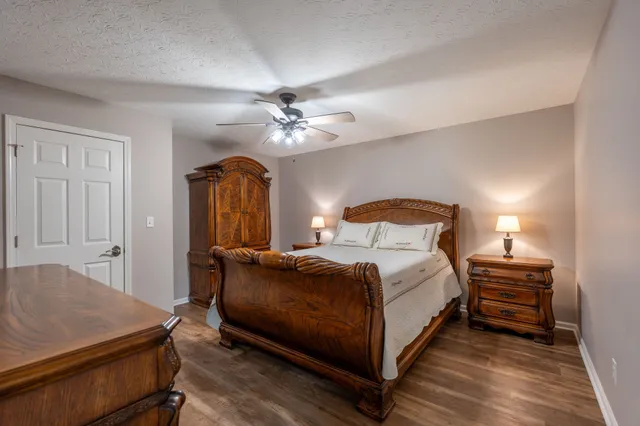 a bedroom with a bed and a chandelier
