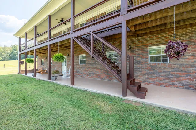 a view of backyard with deck and outdoor seating