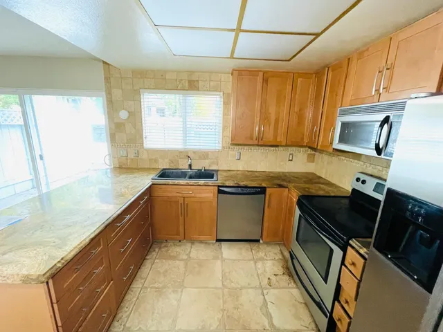 a kitchen with a stove a sink and a microwave