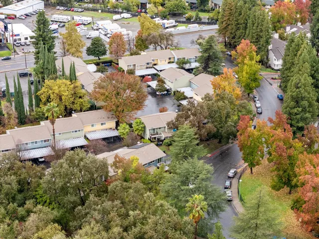 an aerial view of residential house with outdoor space and trees all around
