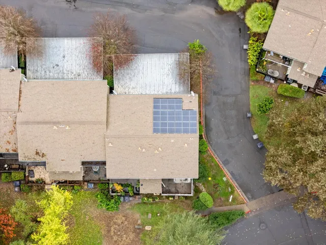 an aerial view of a house with a yard