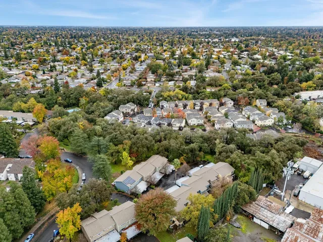 an aerial view of a house with a yard