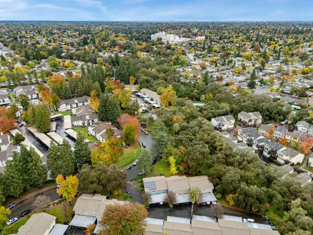 an aerial view of residential houses with city view