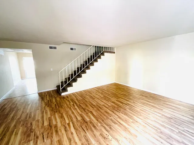 a view of entryway and hall with wooden floor