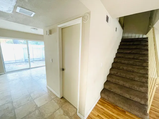 a view of entryway with stairs and wooden floor