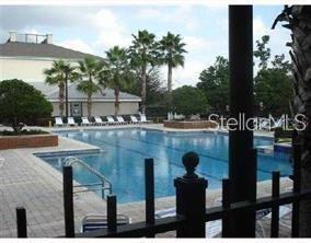 6413 Astor Village Avenue, Unit 212 Orlando, FL 32835 - Photo 15 of 16 a view of swimming pool with seating space and yard