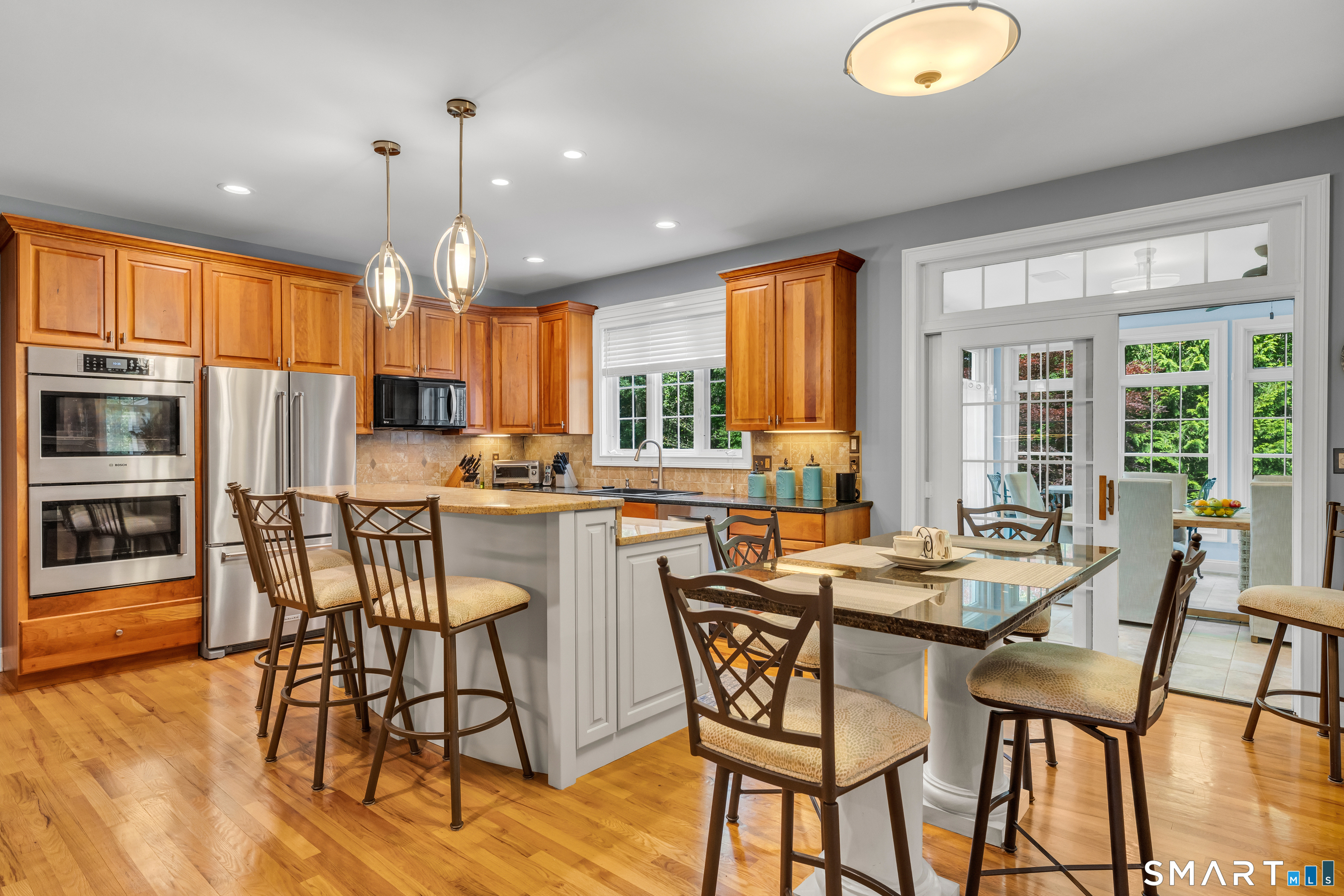 11 Timber Lane Guilford, CT 06437 - Photo 4 of 39 Inviting kitchen with double the seating pleasure and doors to the oversized sunroom/playroom and open to family room with FPL