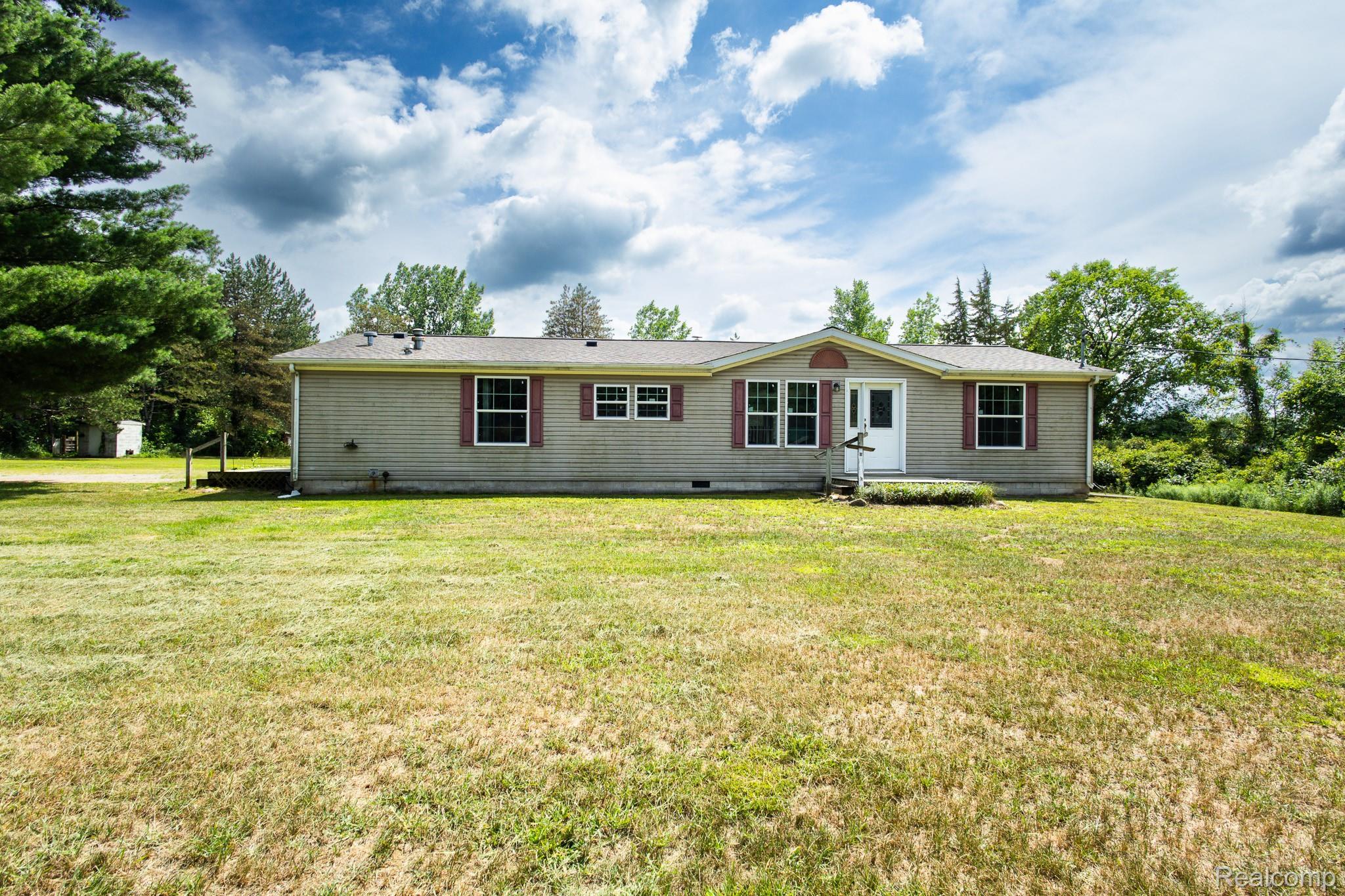 2649 Brown Road Millington, MI 48746 - Photo 1 of 18 Spacious manufactured home featuring a neutral exterior with multiple windows, metal roof, and a covered entry