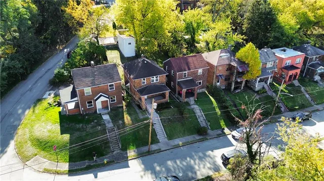 an aerial view of a house with swimming pool garden and patio