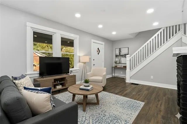 a living room with furniture and a flat screen tv