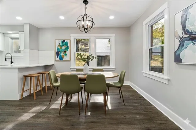 a view of a dining room with furniture a chandelier and wooden floor