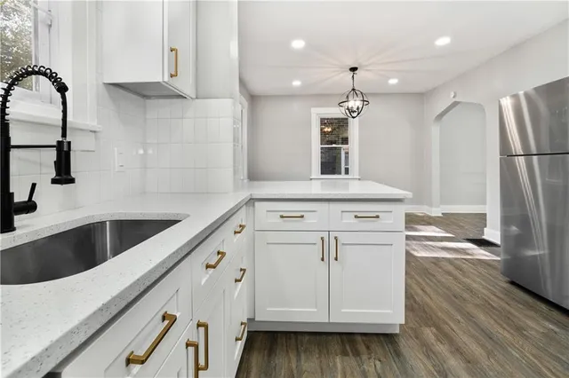 a kitchen with a stove cabinets and wooden floor