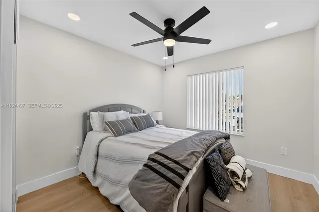 a bedroom with a bed and a ceiling fan