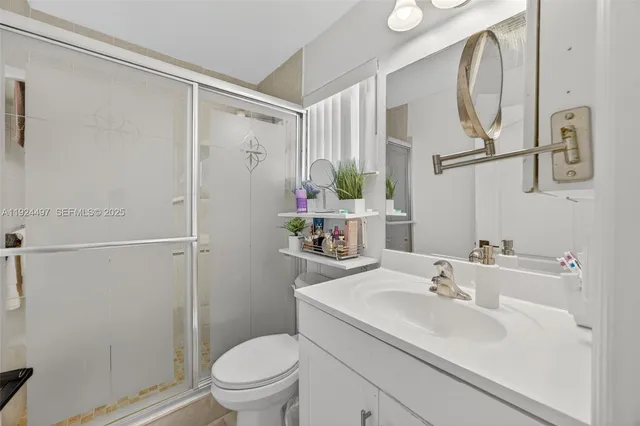 a bathroom with a sink toilet and a mirror