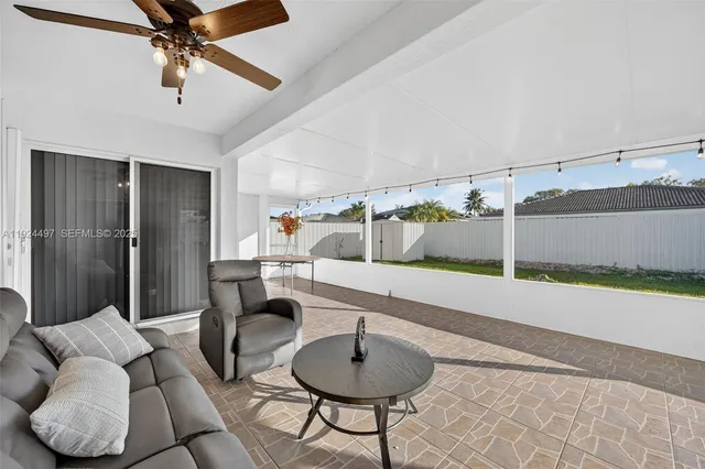 a living room with couch and a ceiling fan