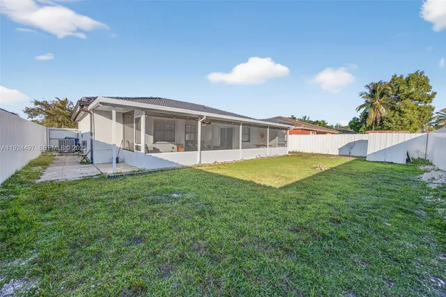 a view of a house with a backyard