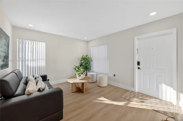 a living room with furniture and a potted plant