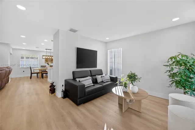 a living room with furniture potted plant and a window