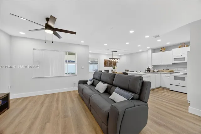 a living room with furniture and kitchen view