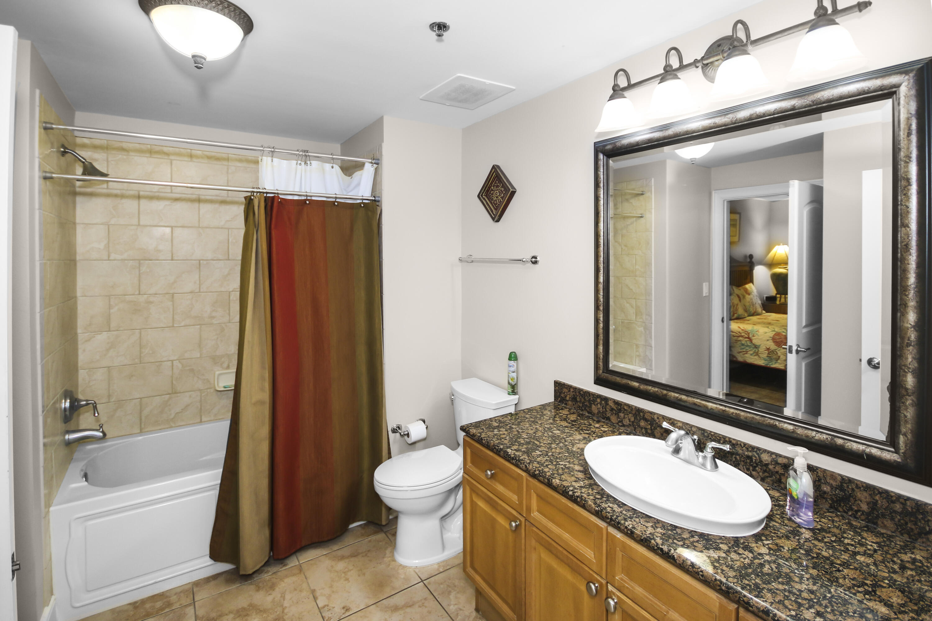 1150 Santa Rosa Boulevard, Unit 502 Fort Walton Beach, FL 32548 - Photo 16 of 43 a bathroom with a granite countertop sink and a mirror